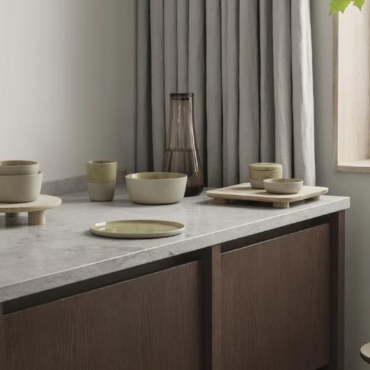 This Glass Carafe has a natural neutral tone that compliments a kitchen and its wooden tones nicely. The glass makes it easy to clean.