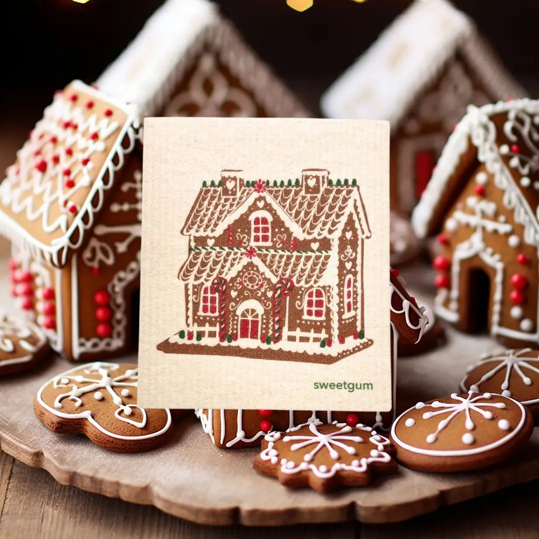 Gingerbread house swedish dishcloth with gingerbread cookies on a wooden surface