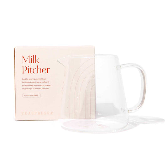 Clear glass pitcher with packaging labeled 'Milk Pitcher' on a white background