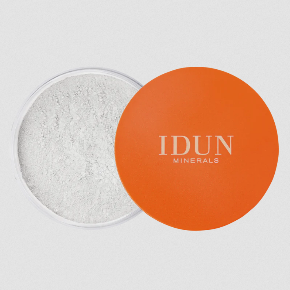 IDUN Minerals Loose Mattifying Powder, with the product container open, showing the white powder inside and the brand's logo on the orange lid.