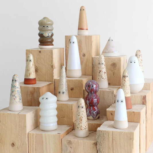 Studio Arhoj Familia in neutral brown and white glazings sitting on wooden raised blocks.
