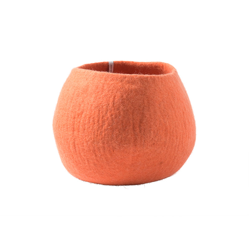 Orange felted wool planter on a white background