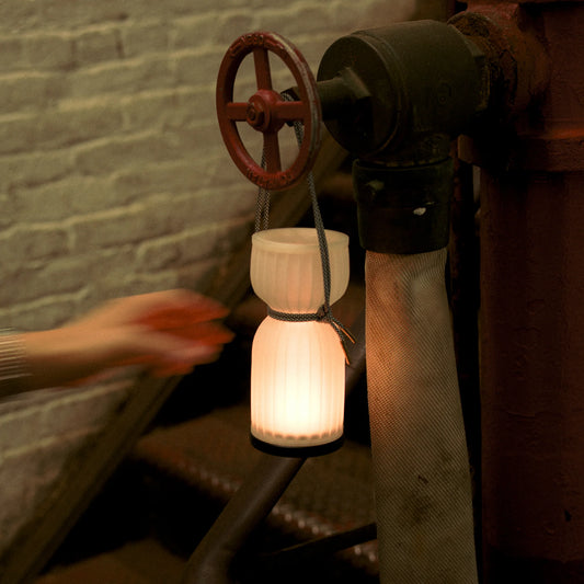 Initially inspired by the shape of water gourds and sake bottles, the Camp Lantern features a playful paracord sling handle, meant to encourage and highlight portability – hang it on a bedpost, take it on a picnic, or simply carry it with you around the house.
Cordless unit is USB-C rechargeable, features three dim-to-warm brightness settings, and lasts for up to 80 hours between charges.