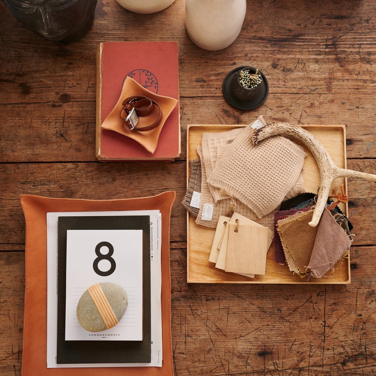 Black ceramic match holder with matches on a coffee table display. Handmade in the United States and looks lovely as a decorative item. Sold at Huset Shop on Abbot Kinney.
