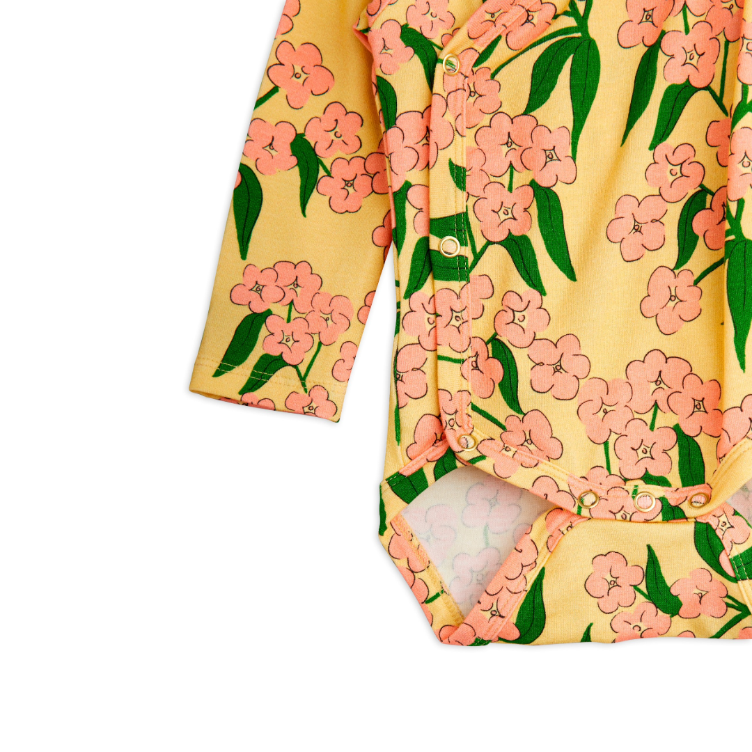 Floral-patterned baby onesie on a white background
