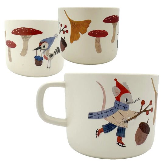 Three ceramic mugs with forest-themed illustrations on a white background