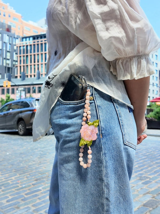 Crafted in small batches and finished with a signature hand-painted charm, this functional accessory is made to fit seamlessly into your day—whether you're running errands, heading out, or just keeping things light.