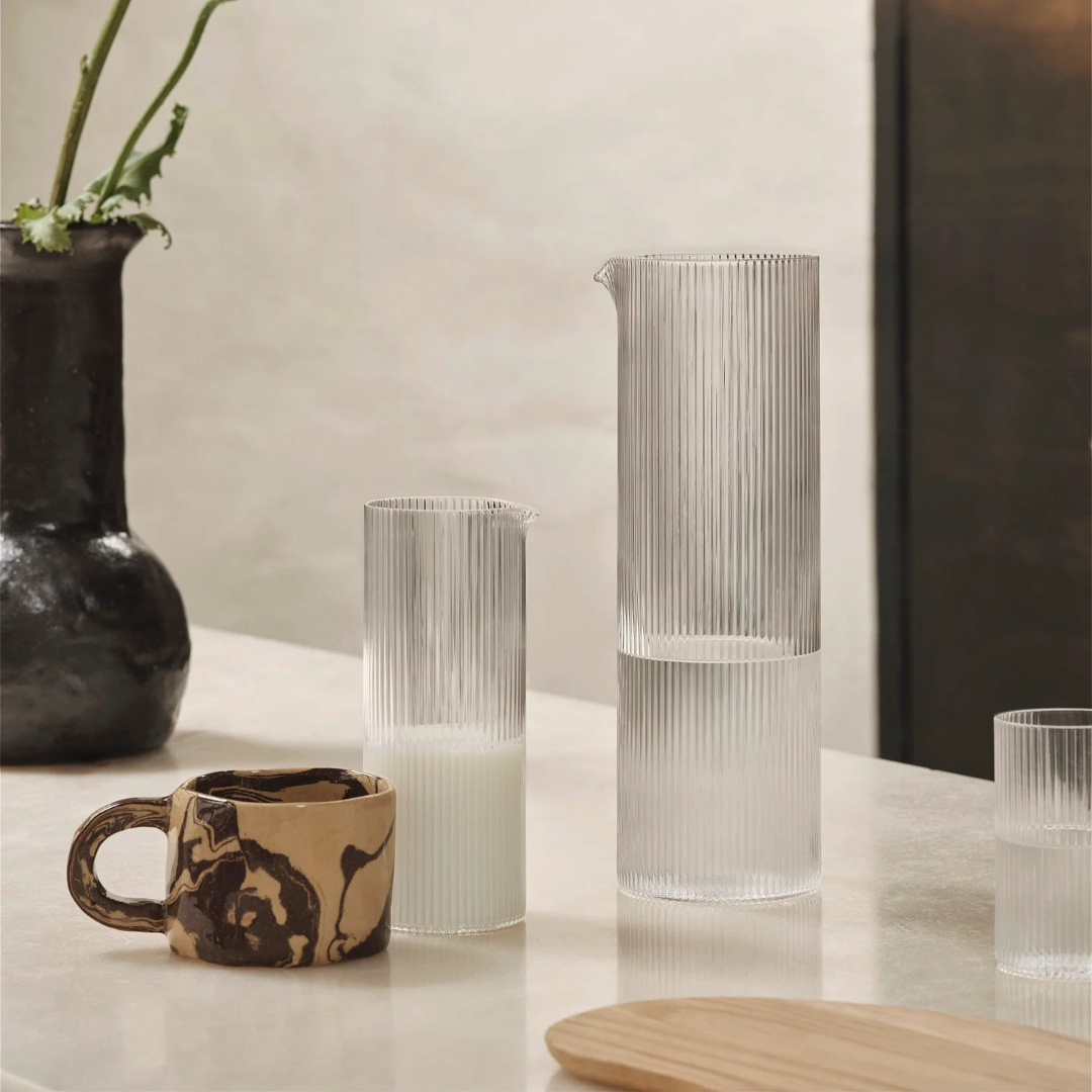 mouth-blown Ripple Water Jug embodies the timeless elegance of the beloved Ripple Family. designed by Ferm Living and sold by Huset in Venice California. We sell Scandinavian design and home ware. This jug would look incredible on the center of a big dinner or party.