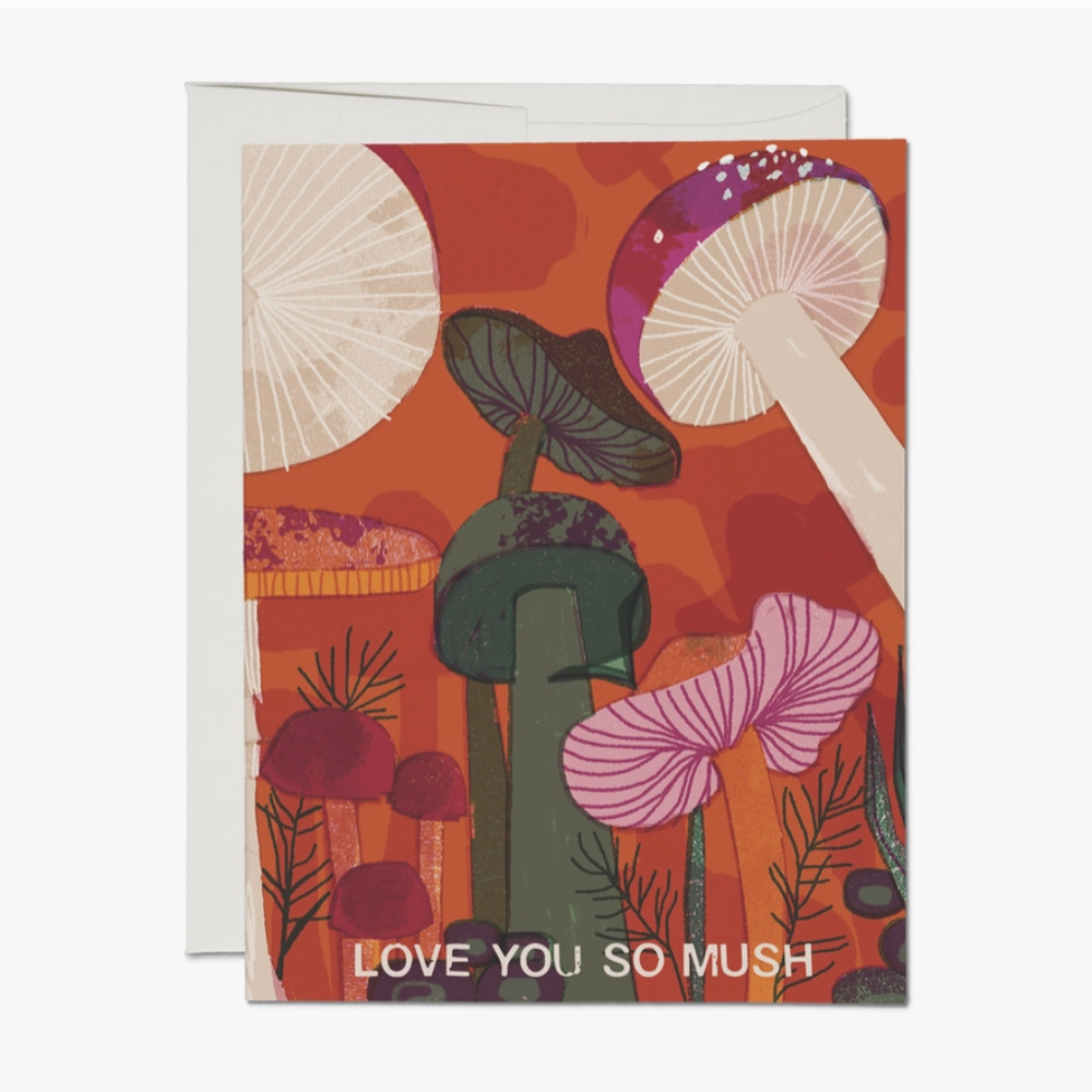 A greeting card with a colorful illustration of mushrooms and the phrase 'LOVE YOU SO MUSH' printed on the front, accompanied by an envelope.