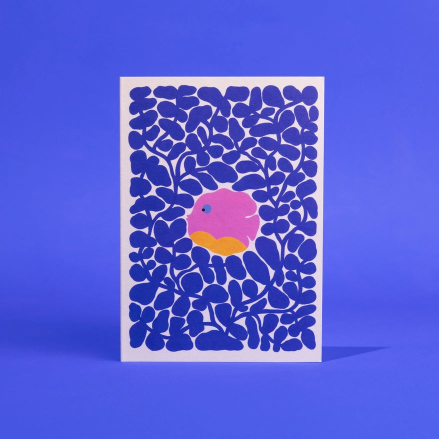 Card with blue abstract pattern and pink and orange center on a blue background it is a dish in coral and supports the ocean and animals in the Amazon.