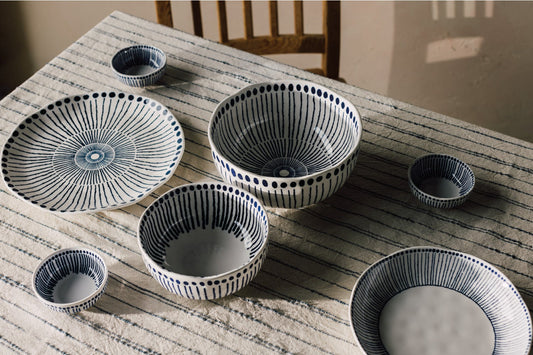 Set of ceramic bowls with decorative patterns on a wooden table.