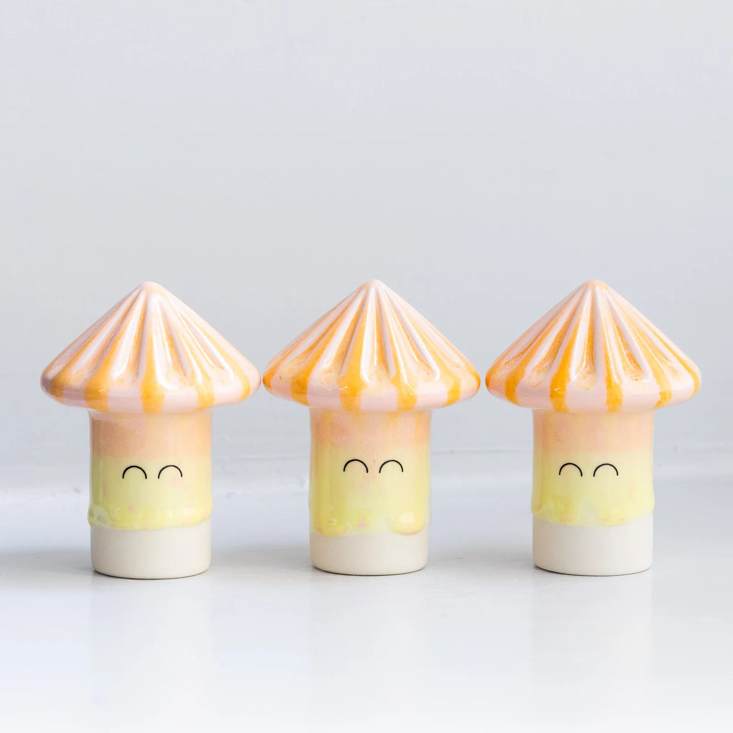 Three of the new shapes that joined the Familia collection at Studio Arhoj. A mushroom shape with a smiling face