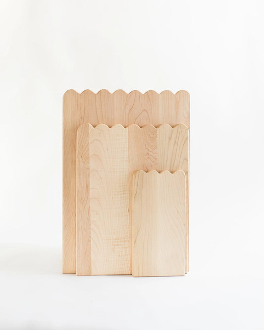 Add whimsical charm to your kitchen with this Scalloped Cutting Board. Handcrafted from solid maple wood and finished with a food grade oil, these cutting boards is a beautiful yet functional addition for daily use.