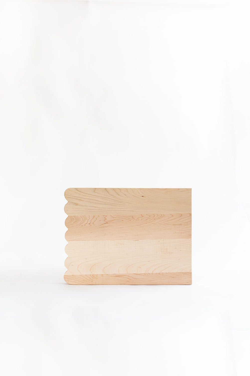 Add whimsical charm to your kitchen with this Scalloped Cutting Board. Handcrafted from solid maple wood and finished with a food grade oil, these cutting boards is a beautiful yet functional addition for daily use.