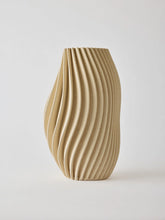 Elegant 3D-printed vase where design meets technology. Each vase features precise lines and intricate details that are difficult to achieve by hand. Made from porcelain clay, the interior is treated to hold water. As the clay is naturally porous, some moisture may pass through, avoid placing it on delicate surfaces. The matte glaze gives a sleek, refined look.