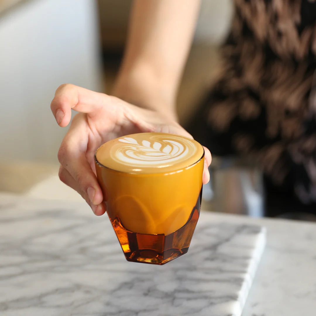 Vero is notNeutral's game-changing collection of glassware for specialty coffee. The collection offers a modern take on traditional bar glasses with technical improvements designed to elevate the experience of pouring and sipping coffee beverages. Their exaggerated facets, satisfying weight, and curved interiors (optimized for pouring latte art) have made them a favorite of coffee drinkers around the world.   