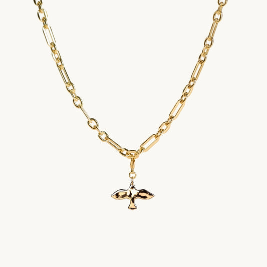 Gold necklace with a small dove pendant on a white background