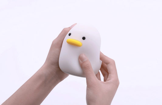 A small duck shaped night lamp designed to accompany you into sleep, a perfect LED night light as bedside table lamp, decoration for dorm, bedroom, nursery, and study room. It features adorable animal appearance, soft and smooth silicone material, comfortable warm yellow light, simple and time-delay switch for versatile and convenience use.