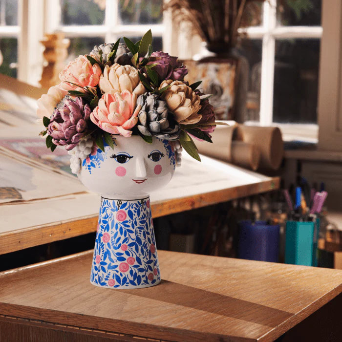 Vase with floral design on a wooden table