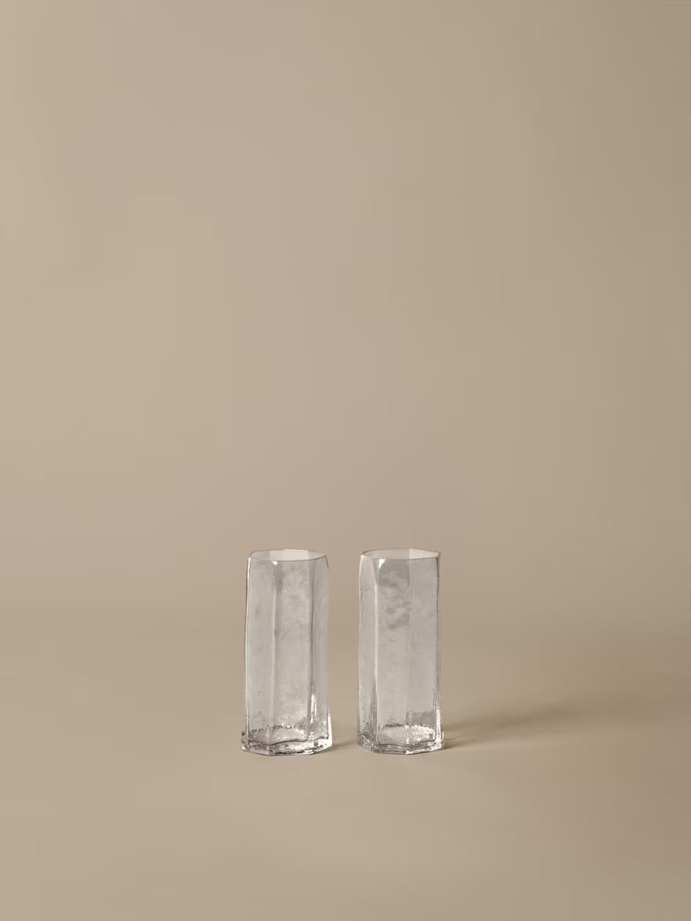Tall glasses set of two on beige background