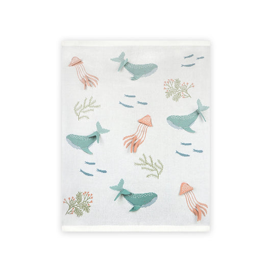 Baby blanket with whale and octopus pattern on a white background