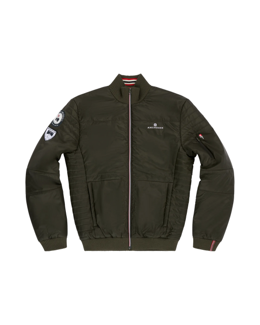 Norwegian camping or hiking, or anything involving the outdoors you will love this jacket. Lightweight durable polyamide face, 120 grams Norwegian Woolinside insulation, Cuffs, waist and neck knitted in pure merino wool, Antarctic Tartan lining
Amundsen Peak patches on upper sleeves. He is using a camping stove to make some coffee surrounded by trees.