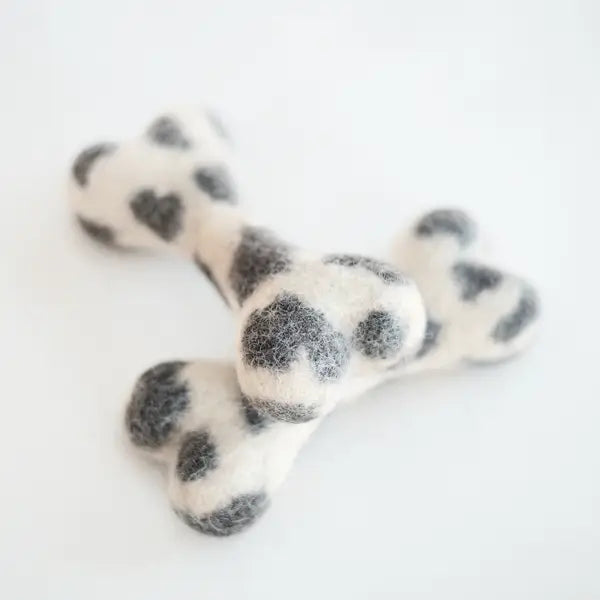Dog chew toy with black spots on a white background