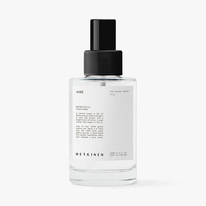 Clear spray bottle labeled 'AIRE' with black cap on a white background