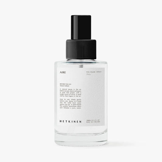 Clear spray bottle labeled 'AIRE' with black cap on a white background