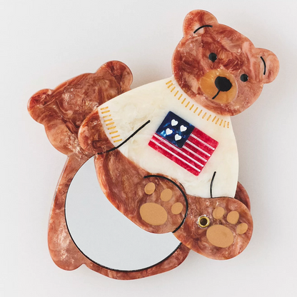 If you are ready to make touching up your makeup a cute task, than this teddy bear mirror wearing an American flag on their sweater is sure to impress.