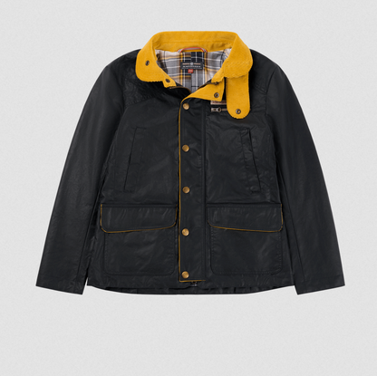 An Amundsen waxed canvas jacket in black with a vibrant yellow sherpa-lined hood and yellow piping details, displayed flat against a light gray background.
