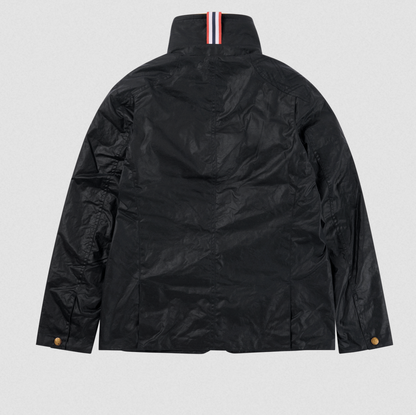 The back view of a black waxed cotton jacket with a high collar featuring a signature red, white, and blue striped ribbons, and brown buttons on the cuffs.