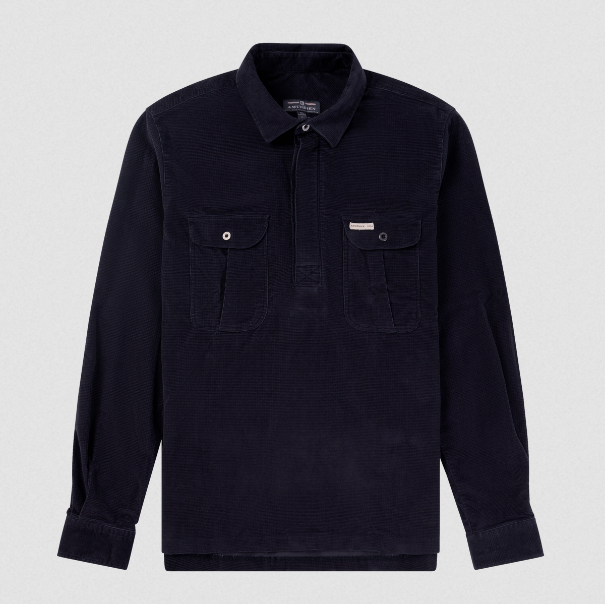 A dark navy corduroy long-sleeve shirt jacket with a buttoned collar, half-placket, and two buttoned chest pockets, displayed on a light gray background.