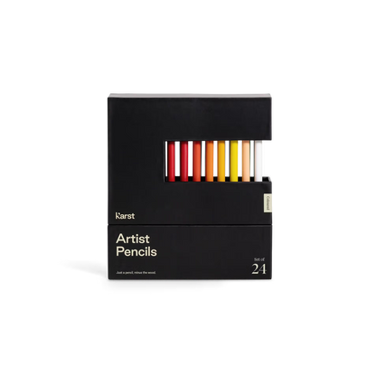 Black box of artist pencils with colorful pencils peeking out on a white background