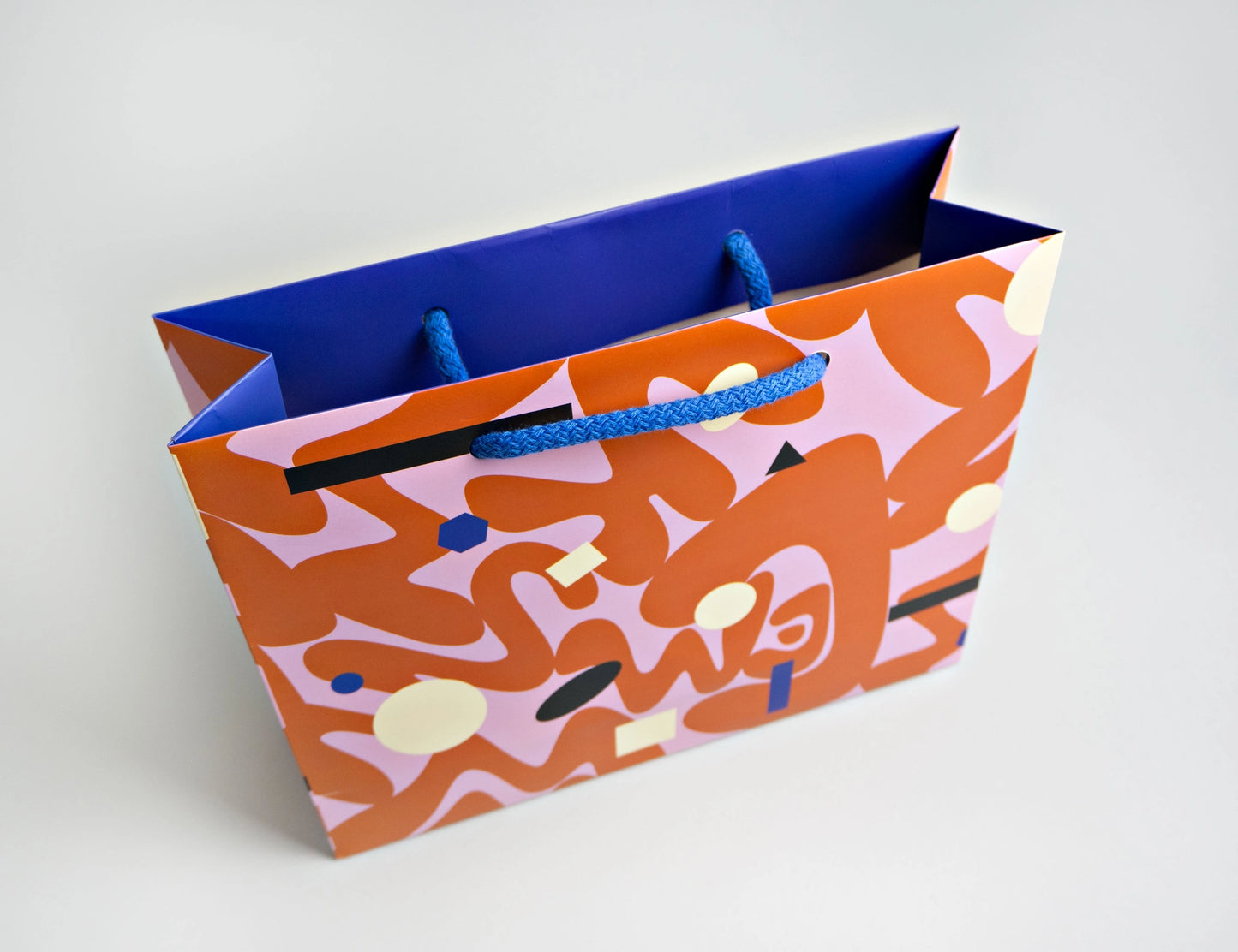 Colorful paper bag with abstract design on a white background