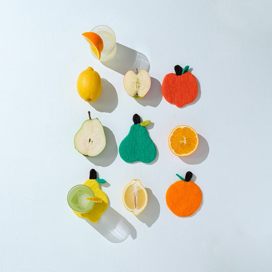 Colorful felt fruit toys on a white background