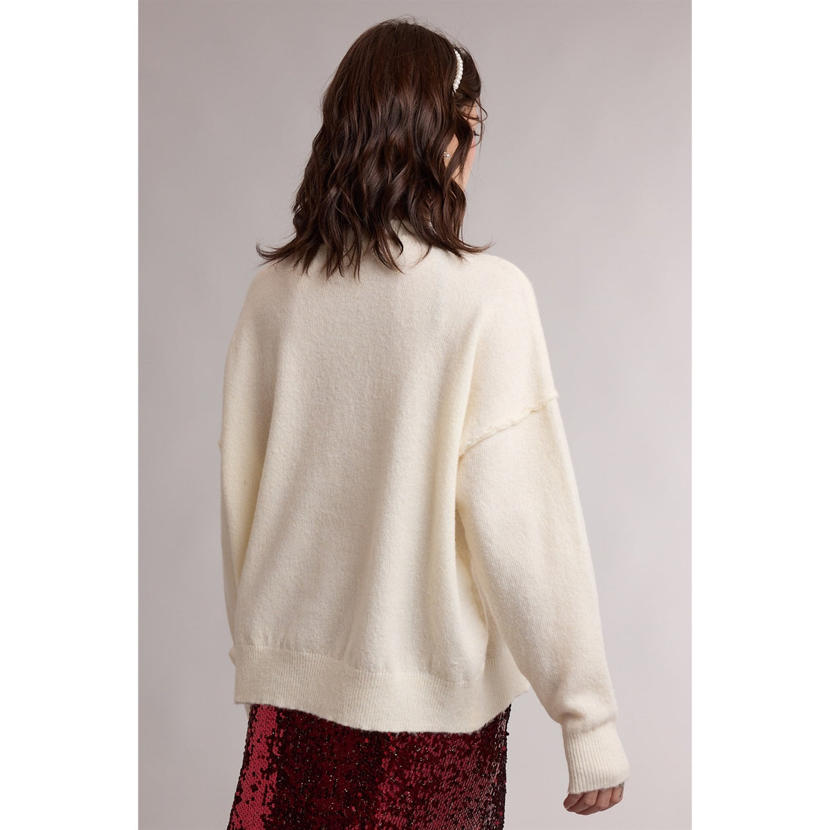 Woman Turned away white beige, off-white sweater