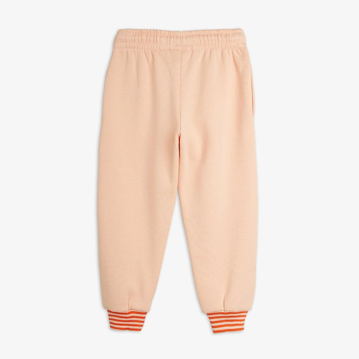 A pair of children's sweatpants in a soft peach color, featuring an elastic waistband and striped cuffs in orange and white.