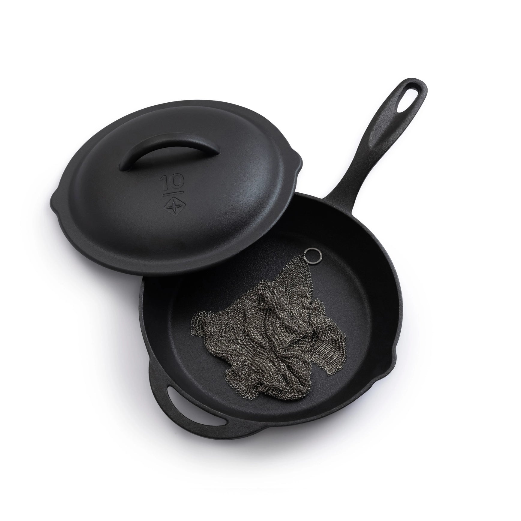 Black cast iron skillet with lid on a white background