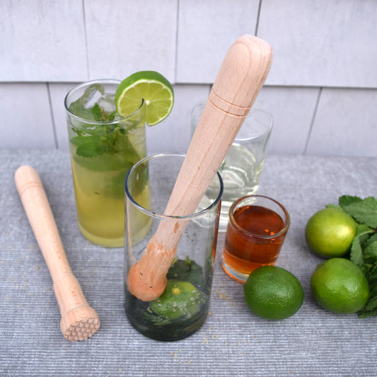 Cocktail preparation with a beechwood muddler squashing limes, honey in order to make a refreshing tantalizing cocktail or mocktail.