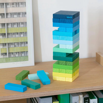 Gradient Green to Blue Jenga Type Game on wooden bookshelf