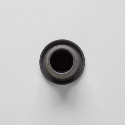 Black ceramic match holder with matches on a gray background. Handmade in the United States and looks lovely as a decorative item. Sold at Huset Shop on Abbot Kinney. 