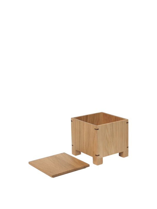 The Bon Garlic Box is a thoughtful addition to the Bon Collection. Crafted from delicate, solid oak sheets, it showcases a refined aesthetic that combines craftsmanship with functionality. The box features precise corner joints and ventilation holes at the base, keeping garlic fresh and dry while protecting it from sunlight. Handcrafted from FSC™-certified wood, the design balances elegance with modern utility, making it a perfect fit for contemporary kitchens.
