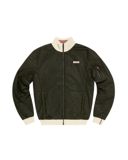 An olive green waxed cotton bomber jacket with cream ribbed trim on the collar, cuffs, and hem, featuring a front zipper, zippered sleeve pocket, and a small rectangular brand patch on the left chest.