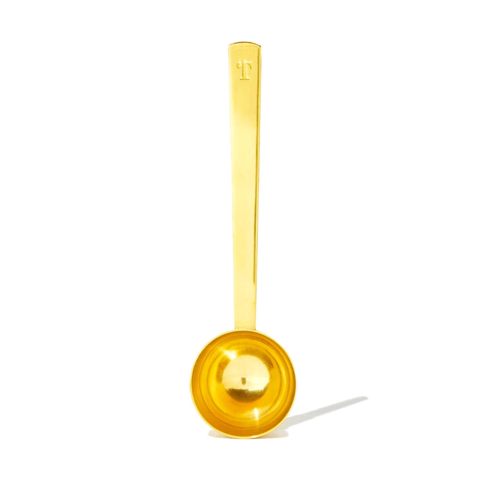 Brushed gold tea scoop, that perfectly measures out a single serving of tea.