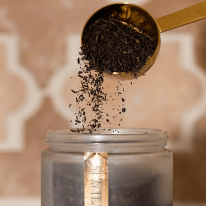 Brushed gold tea scoop, that perfectly measures out a single serving of tea.