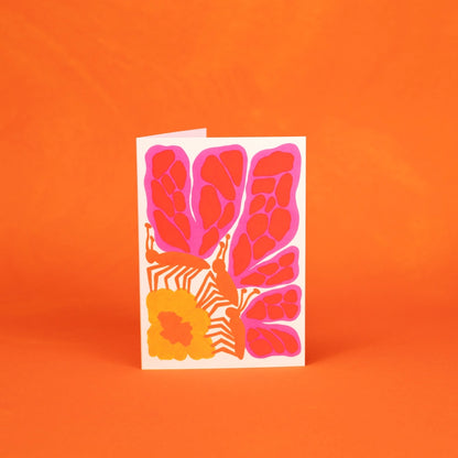 Greeting card with pink floral butterfly design on an orange background