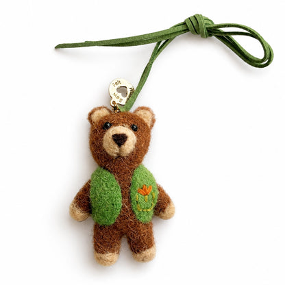 Felt Bear with green cardigan on leather rope bag charm on white background
