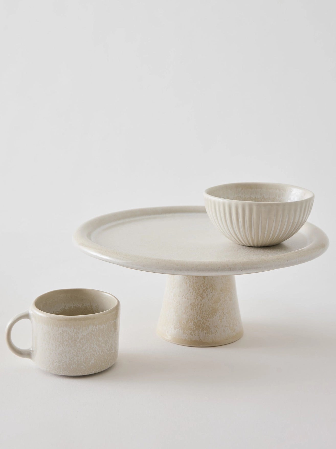 White Stoneware cake stand mug and bowl on white background