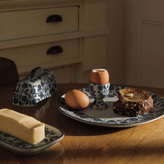 Add a touch of cozy charm to your kitchen with the Danica Butter Dish. Crafted from stoneware ceramic, it blends cottagecore warmth with a sleek, contemporary style. Perfect on its own or paired with matching plateware and utensils, this butter dish turns everyday moments into delightful rituals. Keep your butter fresh and your table stylish with a piece that’s as playful as it is practical.